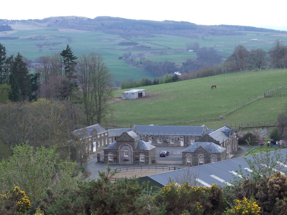An outdoor view of a building and grazing land at Coach House 5 in Perth