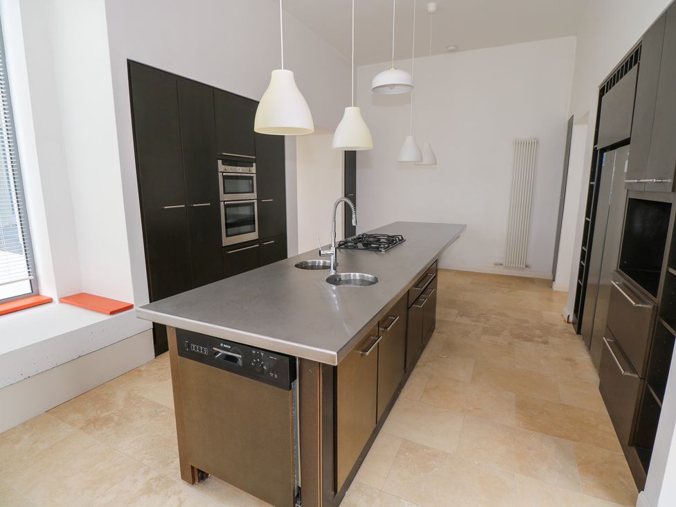 A kitchen with an island and appliances at The Cottage in Ballinagleira