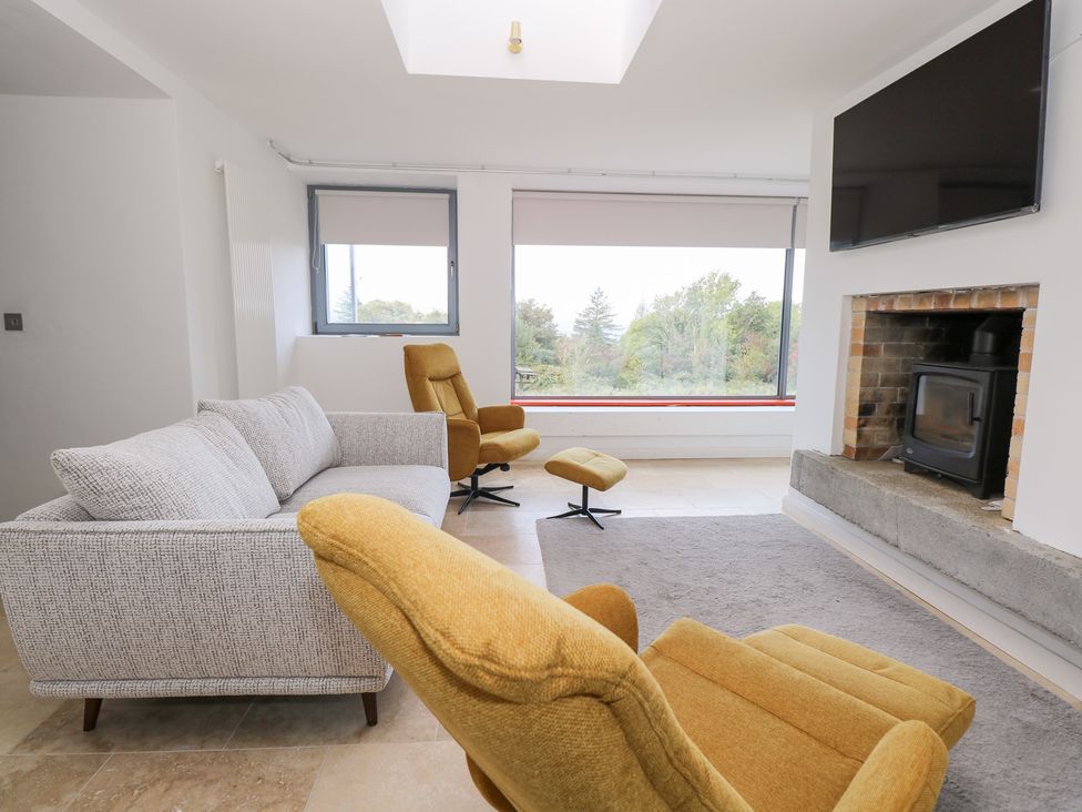 A living room with a sofa and armchair at The Cottage in Ballinagleira