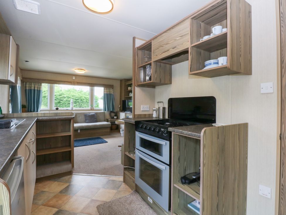 A kitchen with countertop and stove at Mountain View in Pwllheli