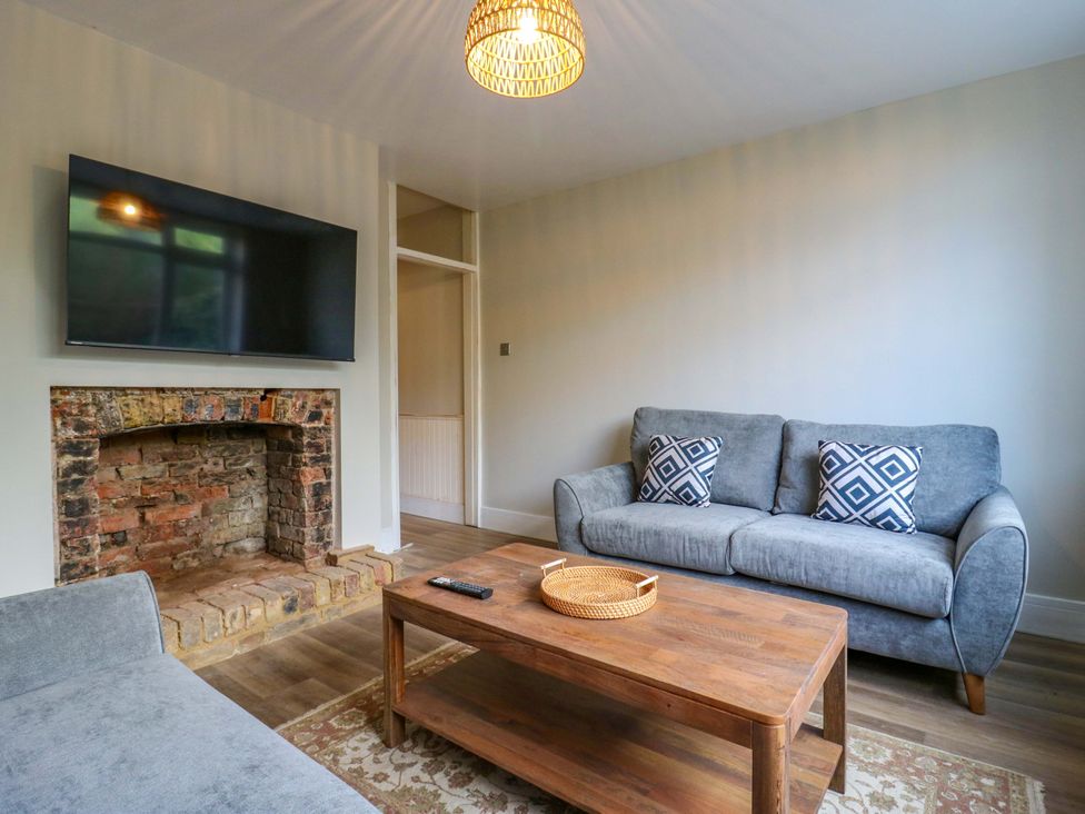A living room with a television and sofa at 13A Westgate Terrace in Whitstable