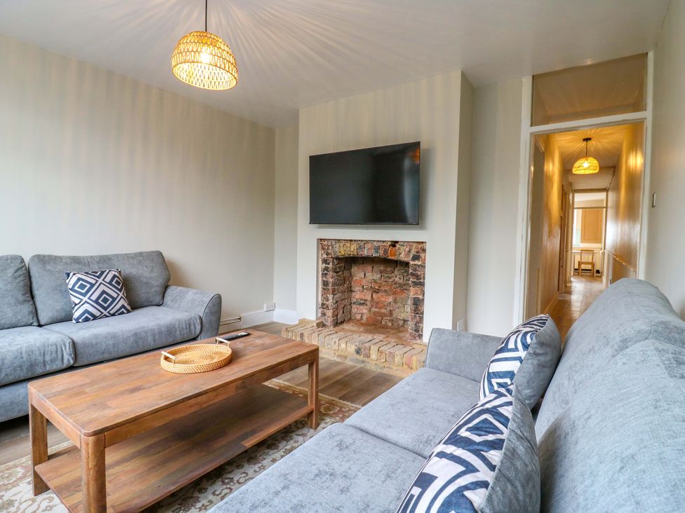 A living room with a television and a fireplace at 13A Westgate Terrace, Whitstable