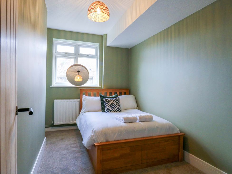 A bedroom with bed and window at 13A Westgate Terrace, Whitstable
