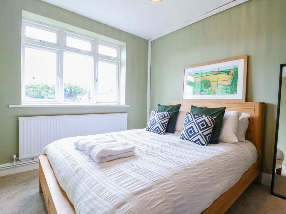 A bedroom with a bed and pillows at 13A Westgate Terrace Whitstable