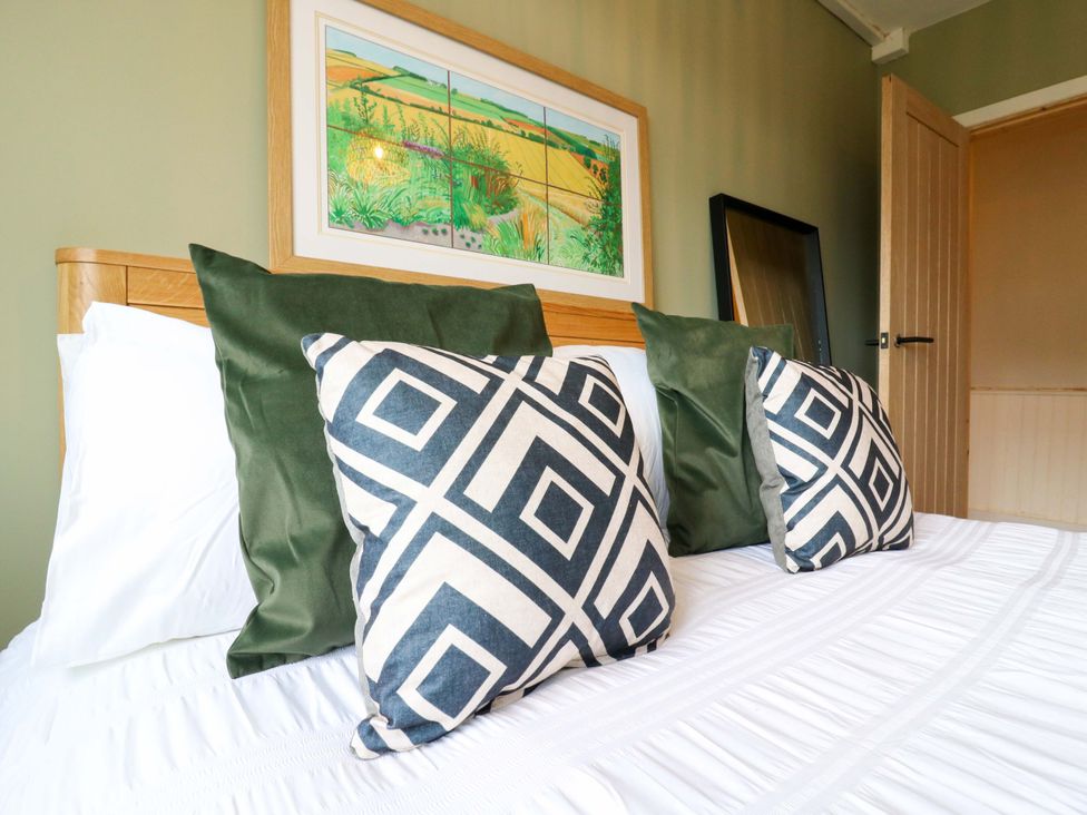 A bedroom with a bed and pillows at 13A Westgate Terrace in Whitstable