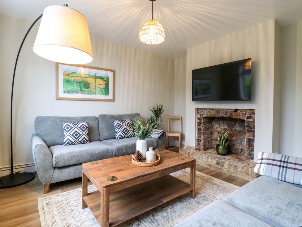 A living room with a sofa and coffee table at High Tide in Whitstable