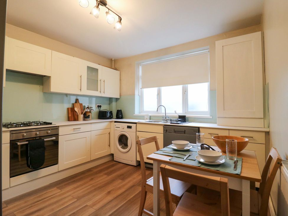 A kitchen with a table and chairs at High Tide in Whitstable