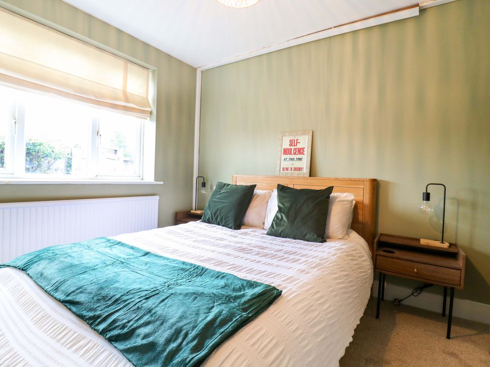 A bedroom with a bed and bedside table at High Tide in Whitstable