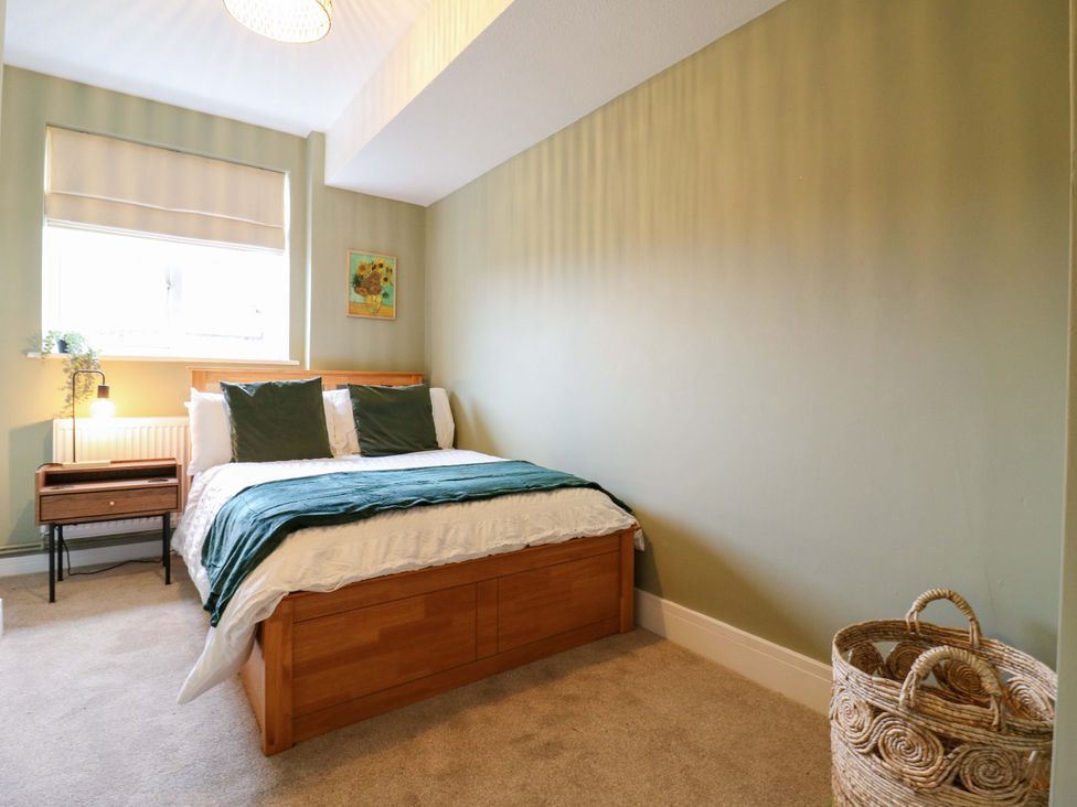 A bedroom with a bed and bedside table at High Tide in Whitstable