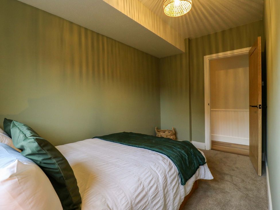 A bedroom with a bed and door at High Tide in Whitstable