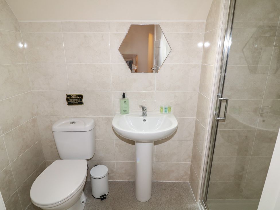 A bathroom with a sink, toilet, and shower at Lodge 8 in Brigg