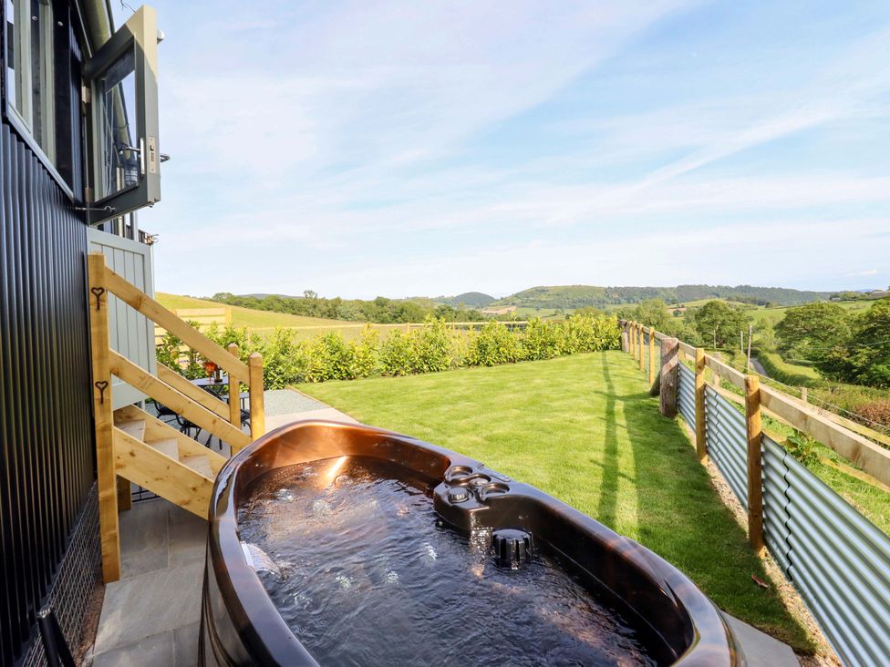 An outdoor area with a hot tub and grass at Charollais in Oswestry