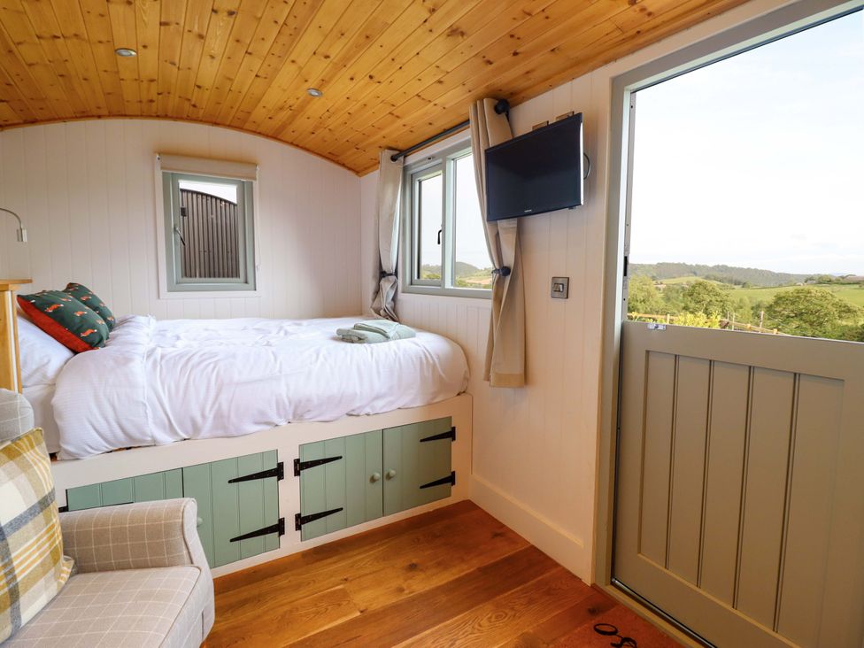 A bedroom with a bed and television at Charollais in Oswestry