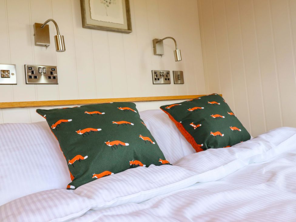 A bedroom with a bed and pillows at Charollais in Oswestry