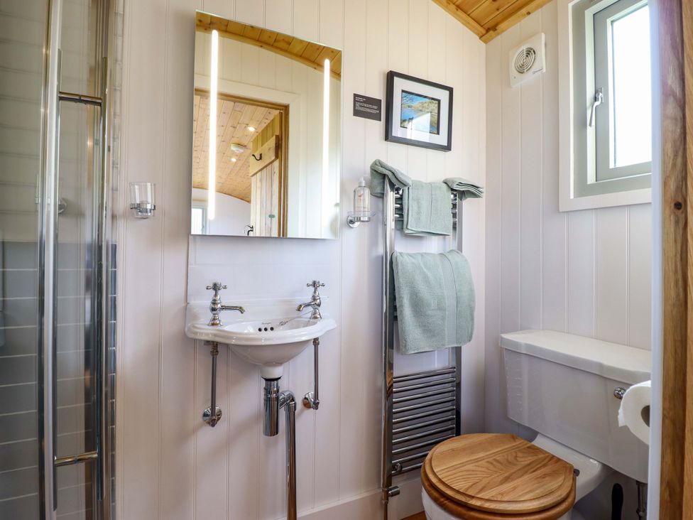 A bathroom with a sink, toilet, and shower at Charollais in Oswestry