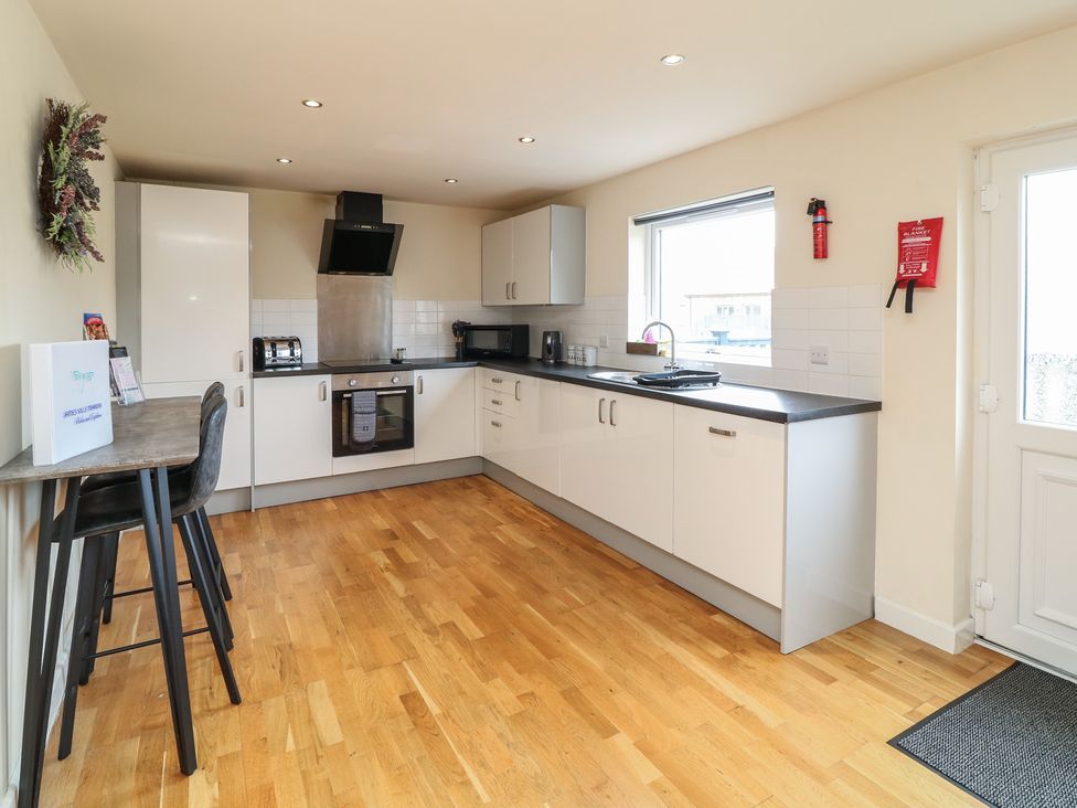 A kitchen with appliances and seating at Lodge 14 in Brigg