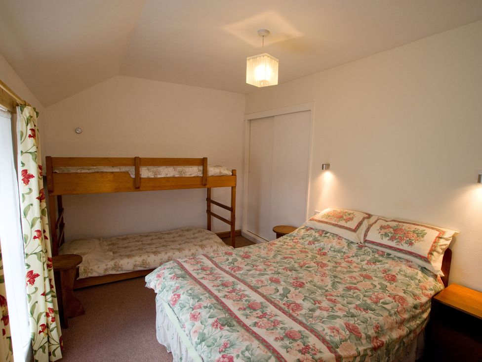 A bedroom with a double bed and a bunk bed at Chyandaunce in Gulval