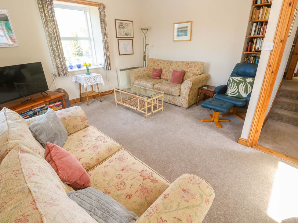 A living room with a sofa, coffee table, and television at Chyandaunce, Gulval
