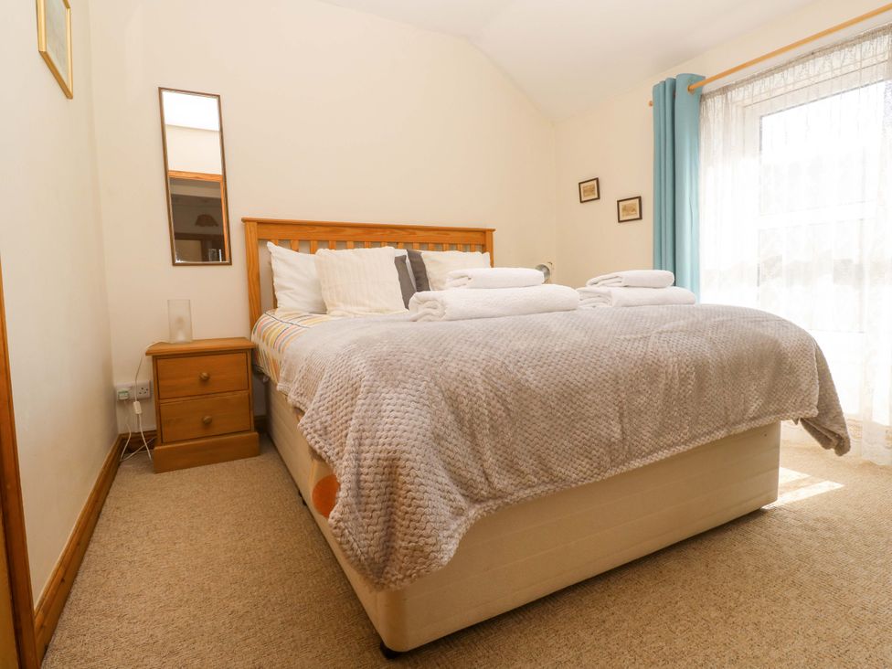 A bedroom with a bed and nightstand at Chyandaunce Gulval