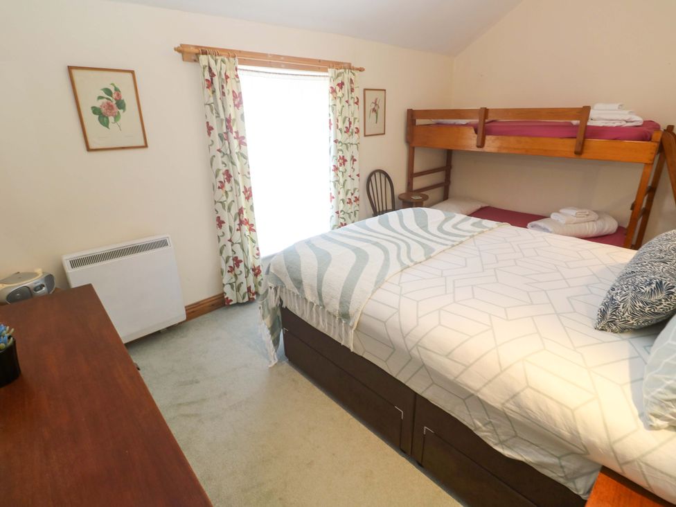 A bedroom with a bed and bunk bed at Chyandaunce in Gulval