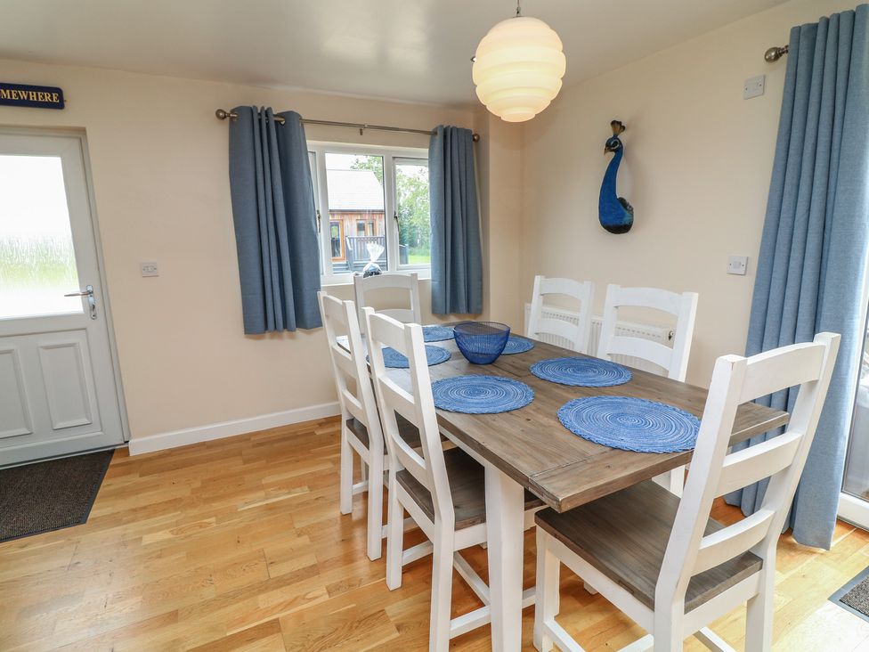 A dining room with a table and chairs at Lodge 21 in Brigg