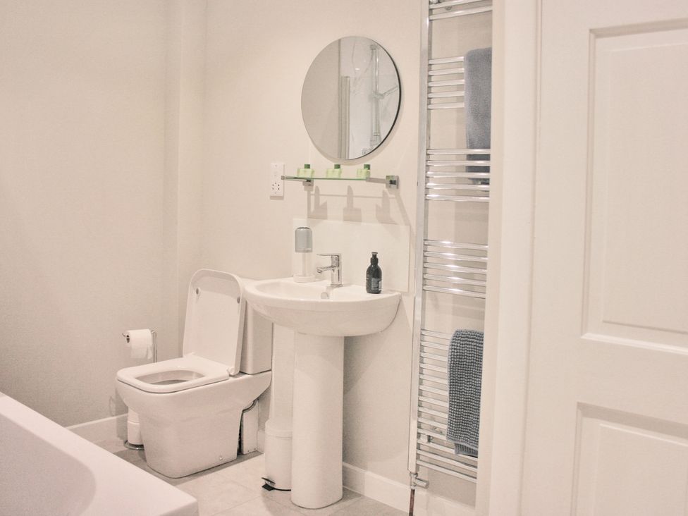 A bathroom with a sink and toilet at 2 Links Place in Nairn
