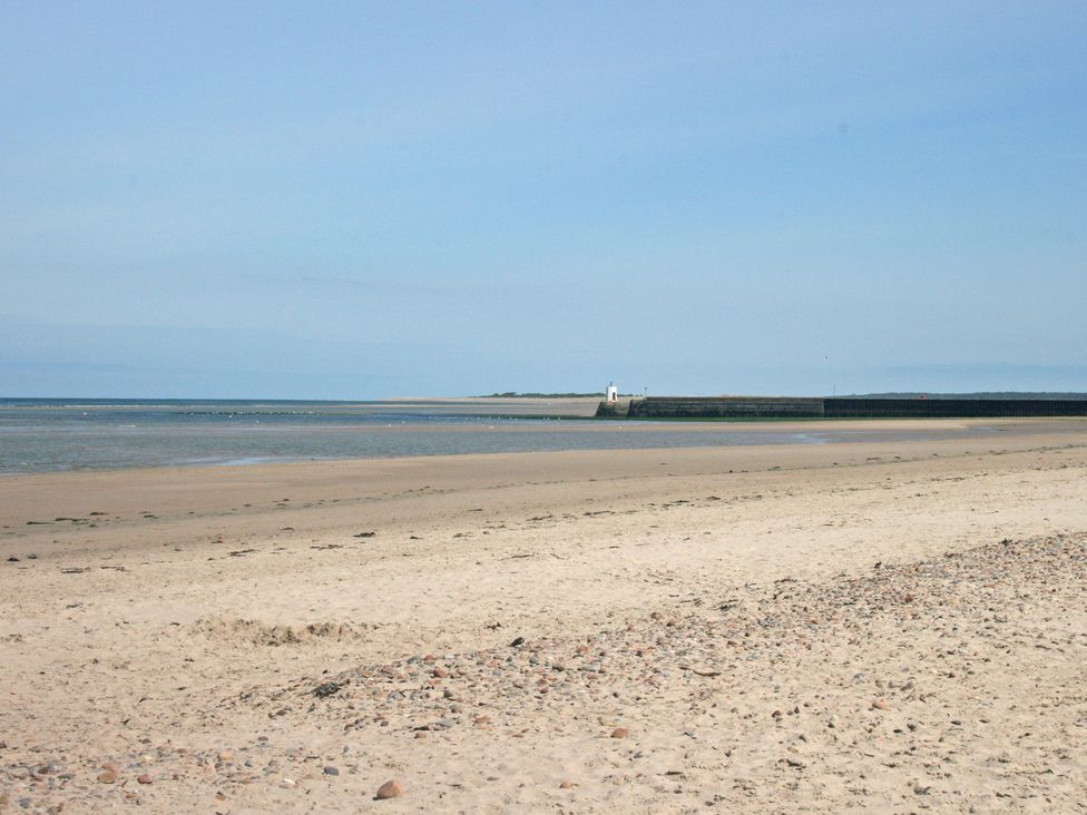 A beach view with sand and sea at 2 Links Place, Nairn