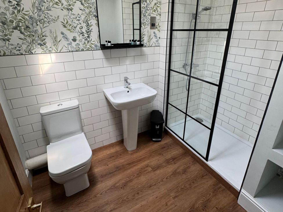 A bathroom with a shower, toilet, and sink at 18 The Wharfage in Ironbridge