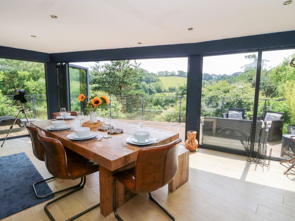 A dining room with a view of the countryside at The Old Barn in Ciliau Aeron near Aberaeron