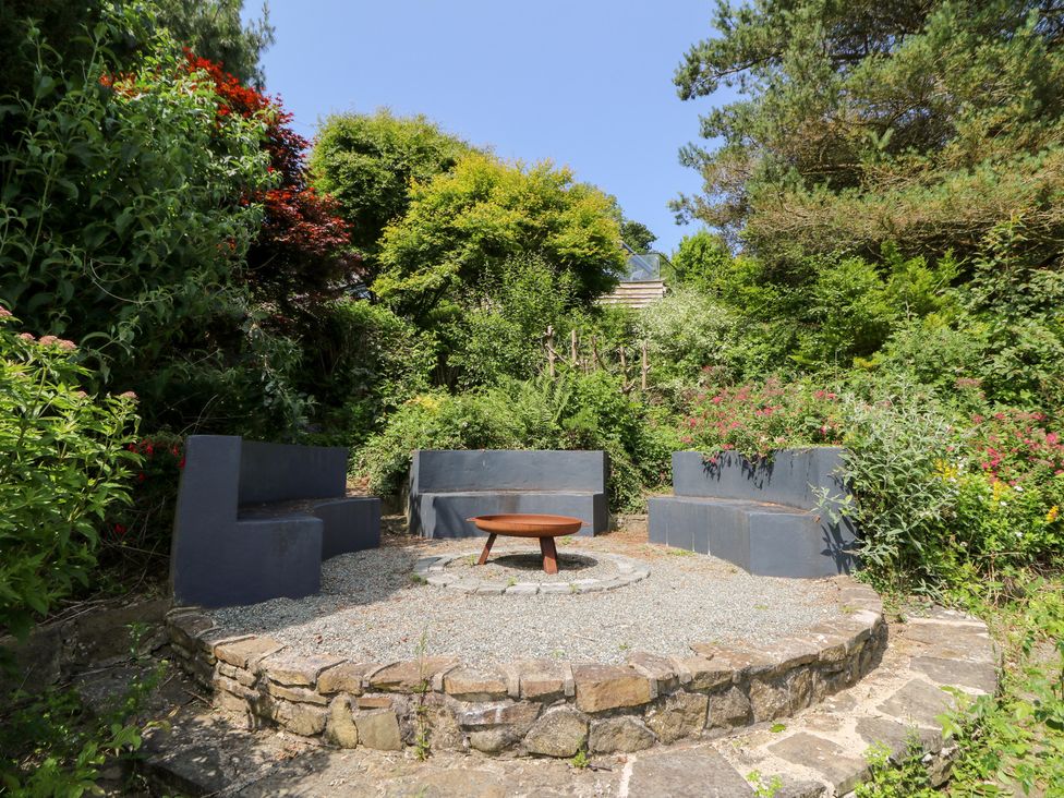 A garden with seating and a fire pit at The Old Barn in Ciliau Aeron near Aberaeron