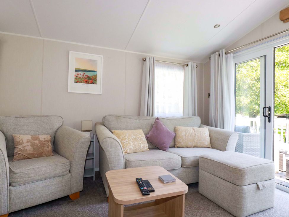 A living room with a sofa and coffee table at Meadow 46 in Newquay