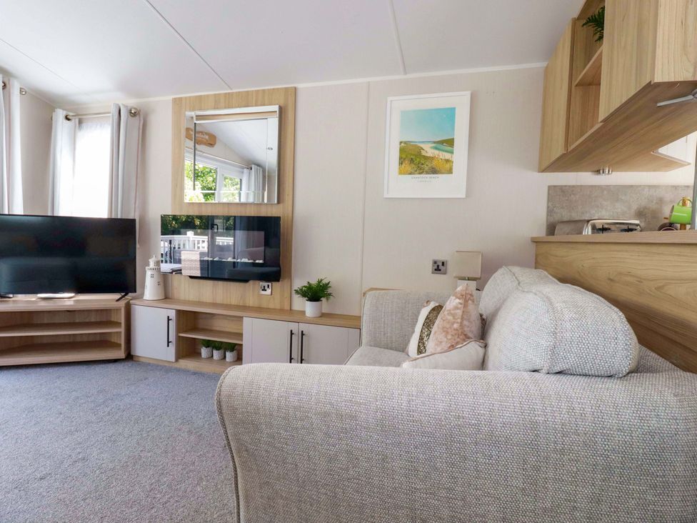 A living room with a television and couch at Meadow 46 in Newquay