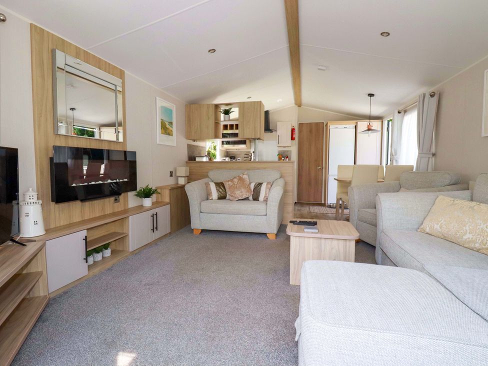A living room with a sofa and coffee table at Meadow 46 in Newquay
