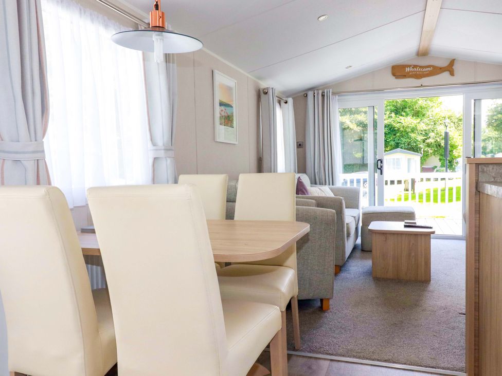 A dining room with a table and chairs at Meadow 46 in Newquay