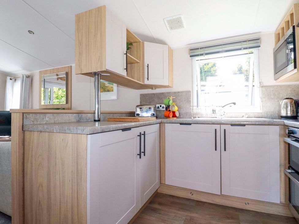 A kitchen with cabinets and a sink at Meadow 46 in Newquay