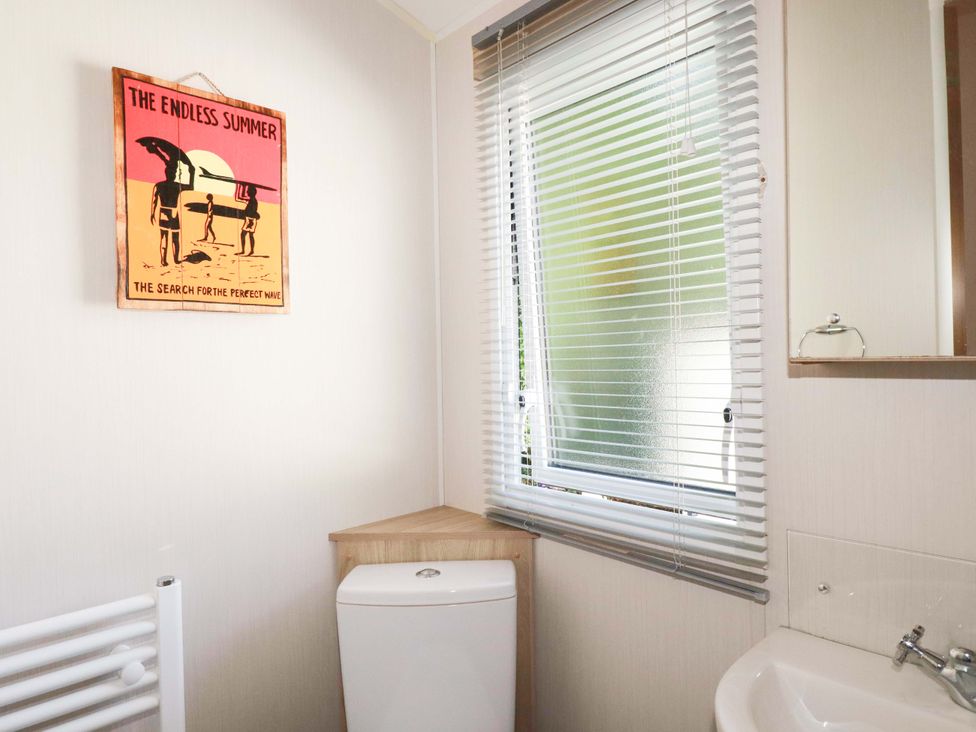 A bathroom with a toilet and sink at Meadow 46 in Newquay