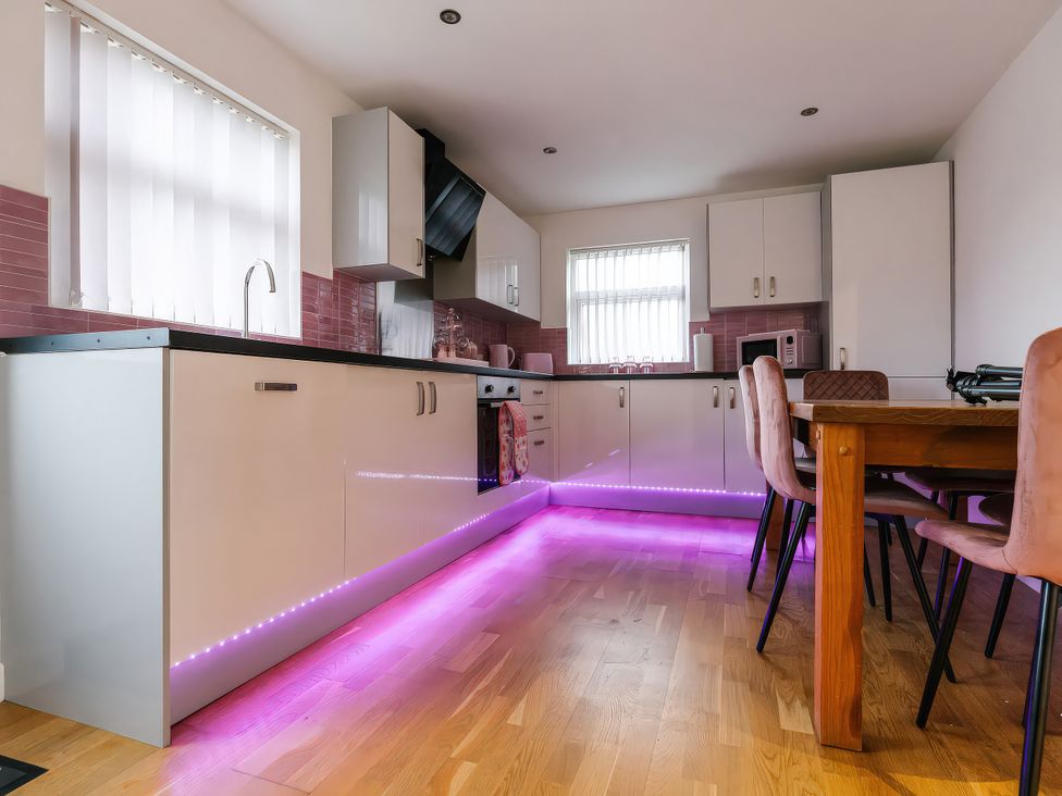 A kitchen with cabinets and a dining table at James Ville Marina Lodge 23 in Brigg