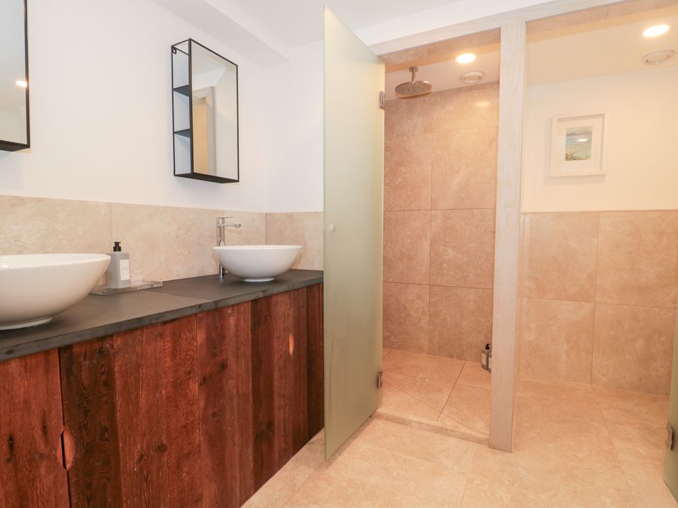 A bathroom with two sinks and a shower at The Threshing Barn Chipping Norton