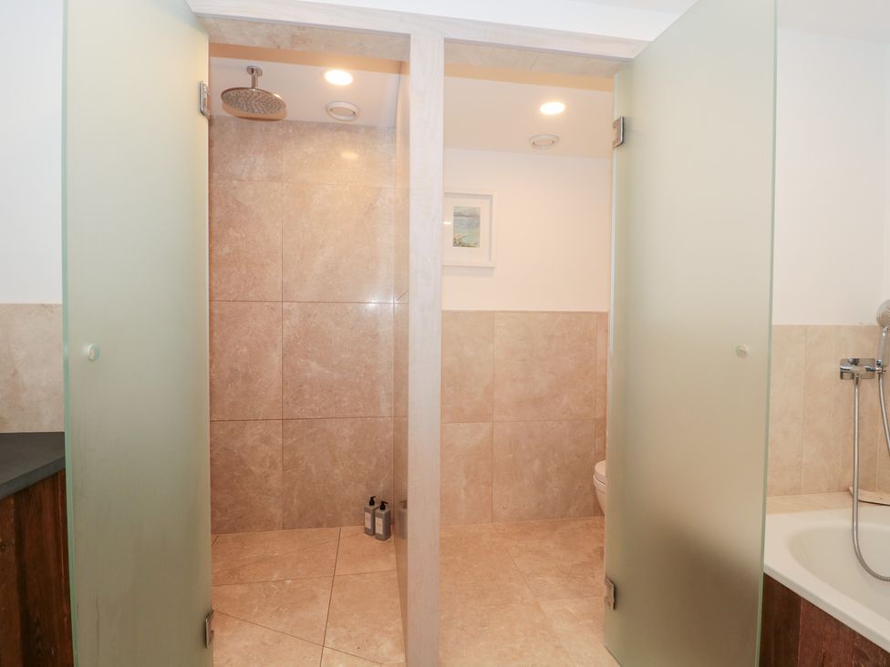 A bathroom with shower and toilet at The Threshing Barn in Chipping Norton