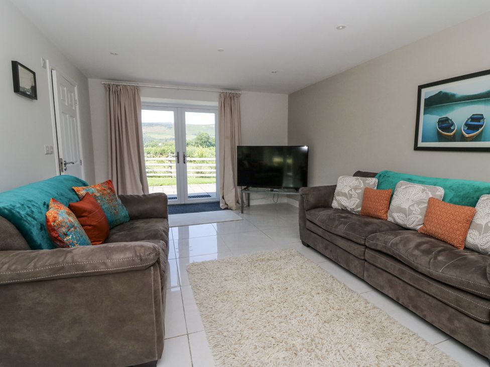 A living room with sofas and a television at Little Penrhosgoch Barn Llandrindod Wells