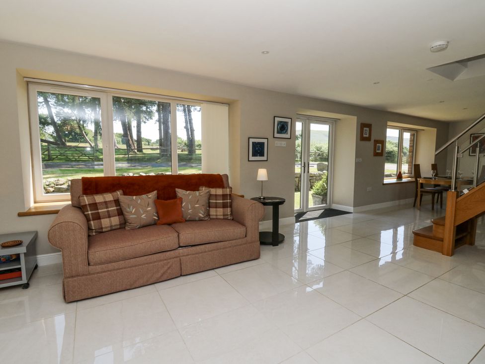 A living room with a sofa and coffee table at Little Penrhosgoch Barn in Llandrindod Wells