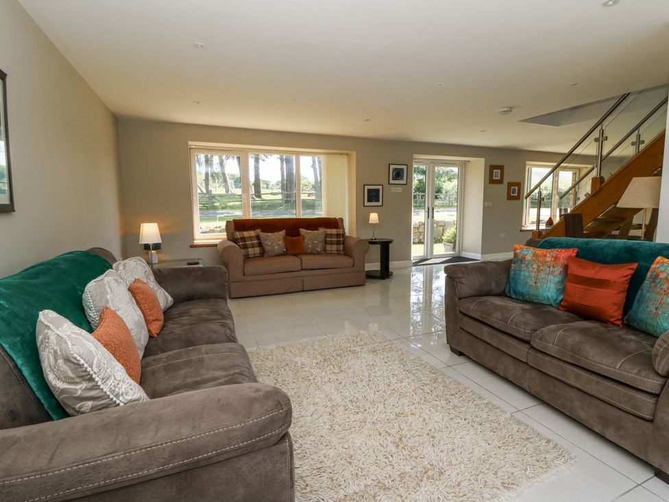 A living room with sofas and a coffee table at Little Penrhosgoch Barn in Llandrindod Wells