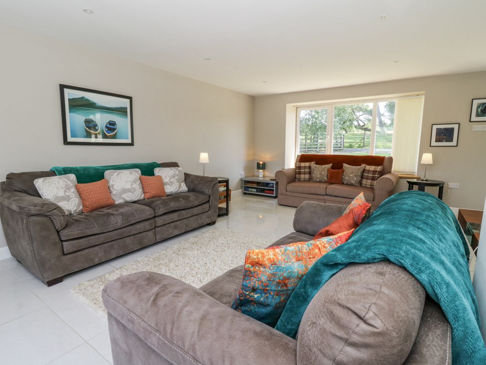 A living room with sofas and a coffee table at Little Penrhosgoch Barn Llandrindod Wells