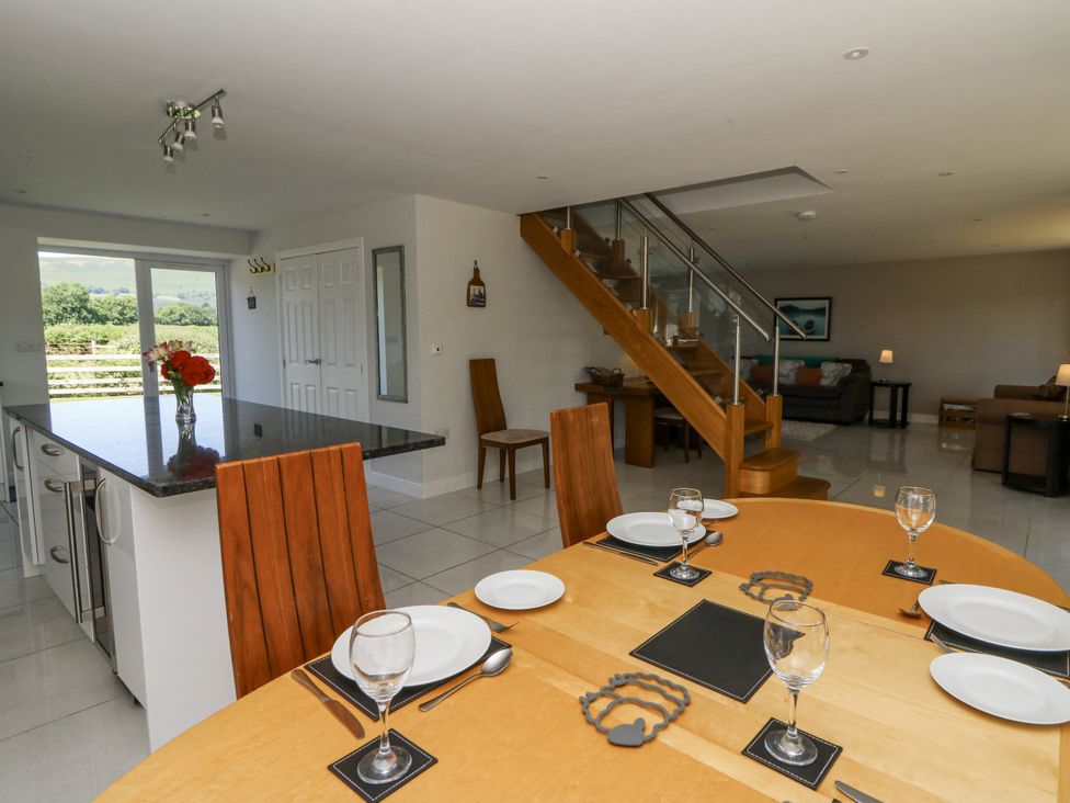 A dining room with a table and chairs at Little Penrhosgoch Barn in Llandrindod Wells