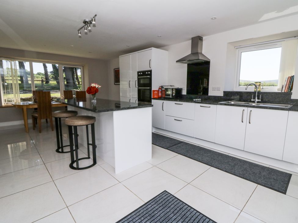 A kitchen with countertop and dining area at Little Penrhosgoch Barn Llandrindod Wells