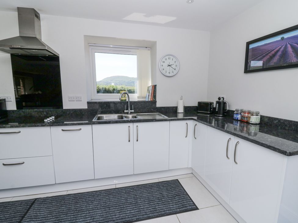 A kitchen with sink and cabinets at Little Penrhosgoch Barn in Llandrindod Wells