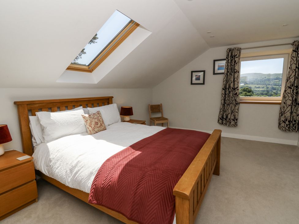 A bedroom with a bed and bedside tables at Little Penrhosgoch Barn in Llandrindod Wells