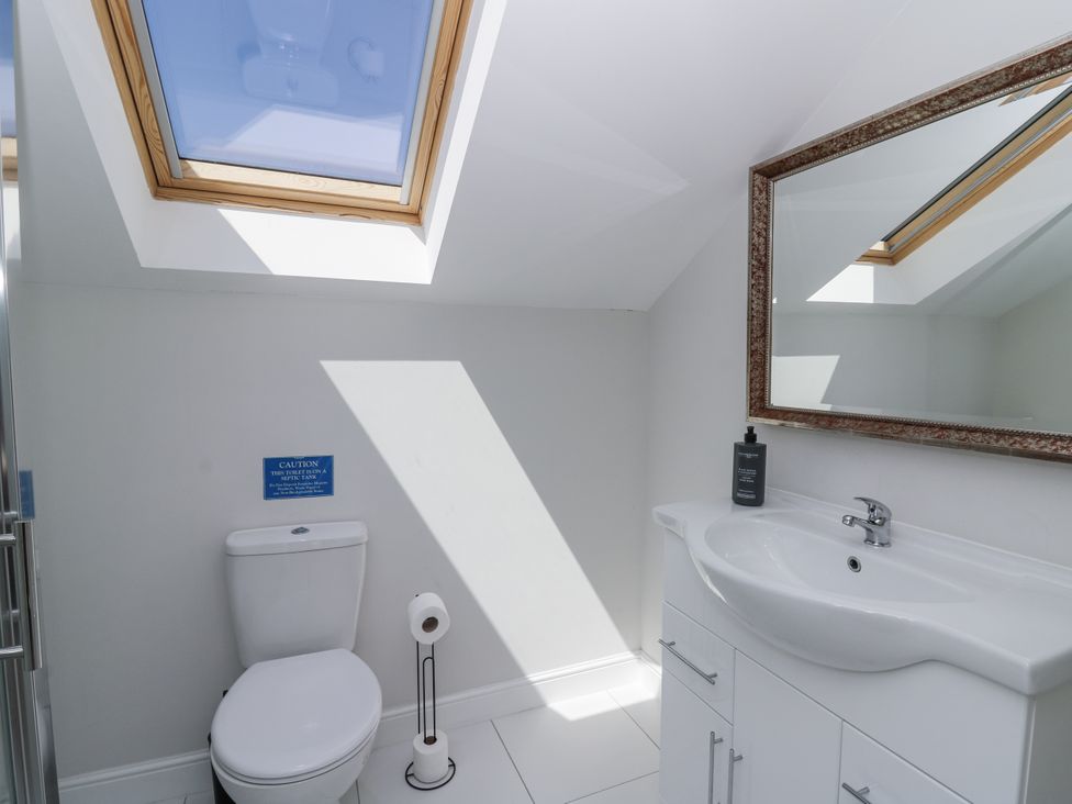 A bathroom with a sink and a toilet at Little Penrhosgoch Barn in Llandrindod Wells