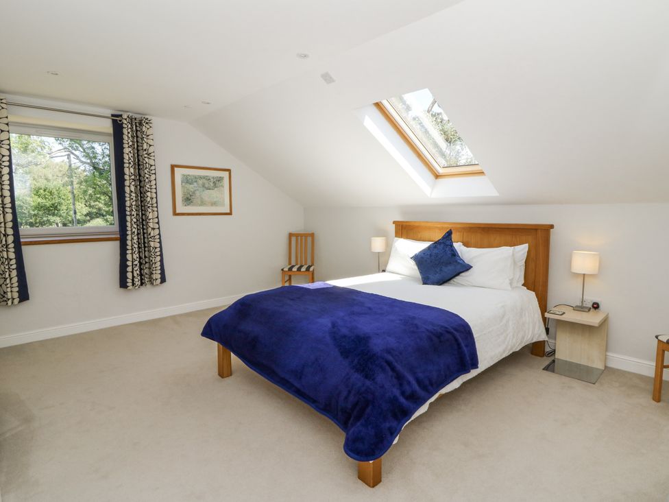 A bedroom with a double bed and nightstand at Little Penrhosgoch Barn Llandrindod Wells