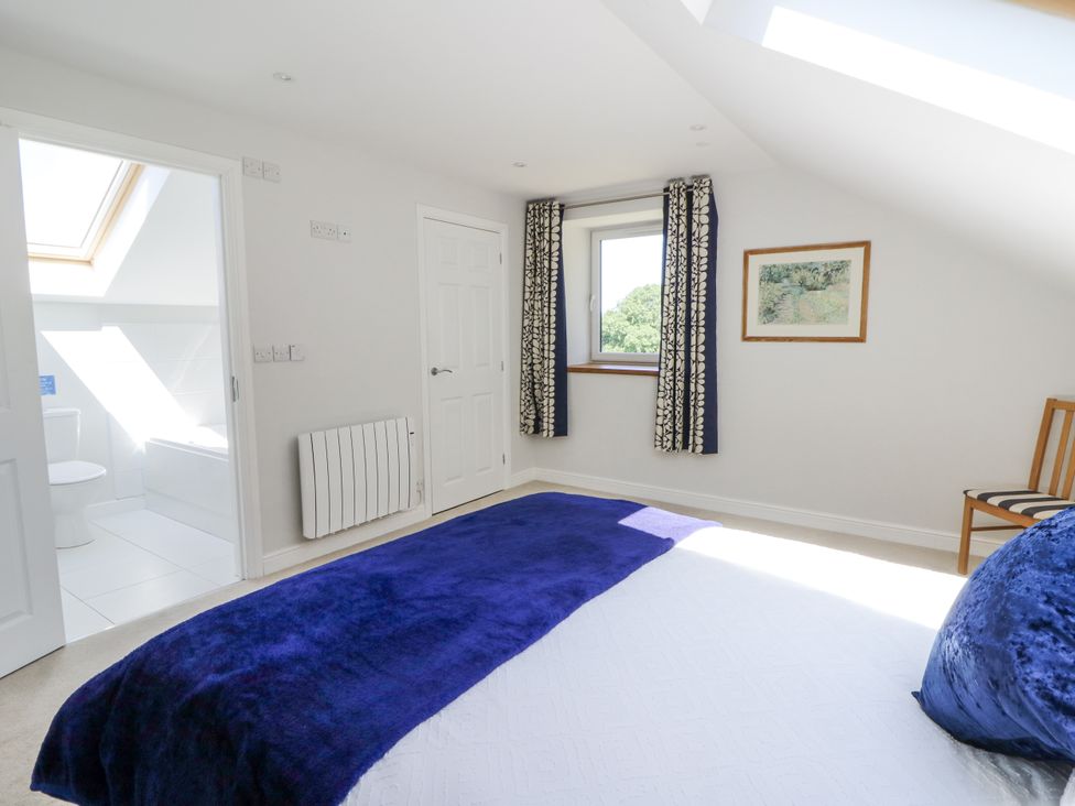 A bedroom with a bed and window at Little Penrhosgoch Barn Llandrindod Wells